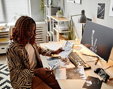 woman in her office working by computer looking at images